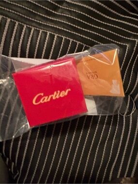 Rotary Watches red and gold pouch with orange card